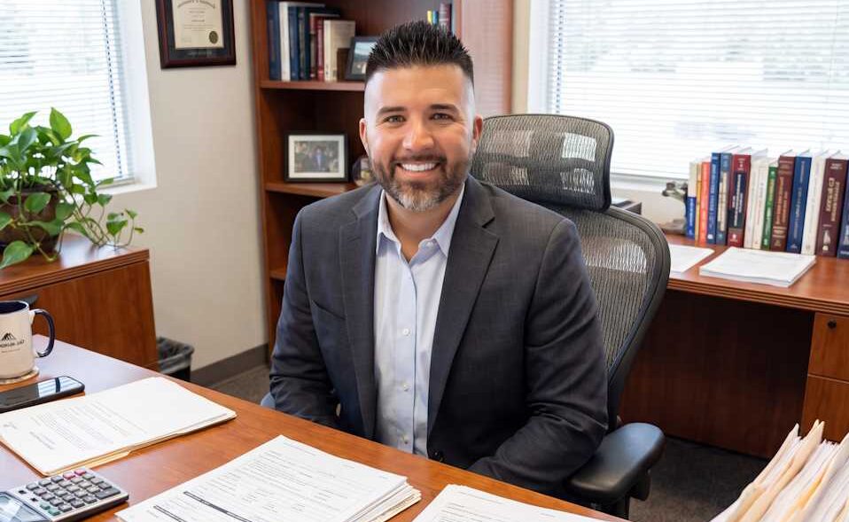 Seth Bennett, Producing Branch Manager at V.I.P. Mortgage, working at his desk in the Fort Wayne, Indiana branch office